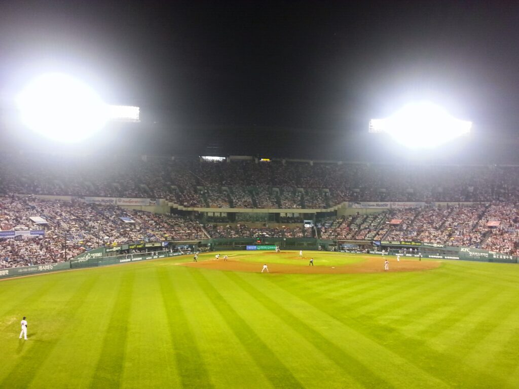 Korean baseball stadium illuminated during night game