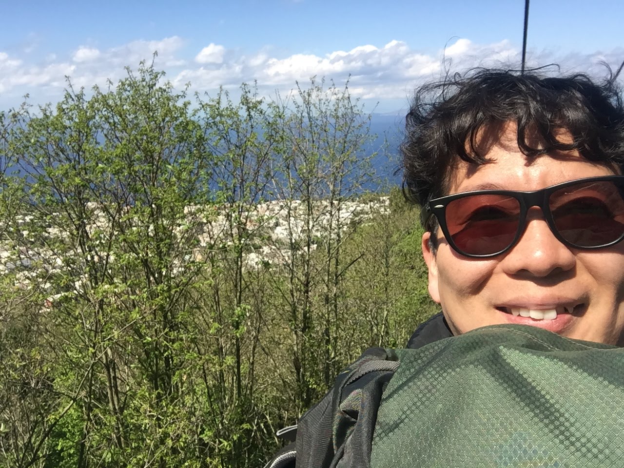 Foreigner taking photo on mountain hiking trail with clear sky