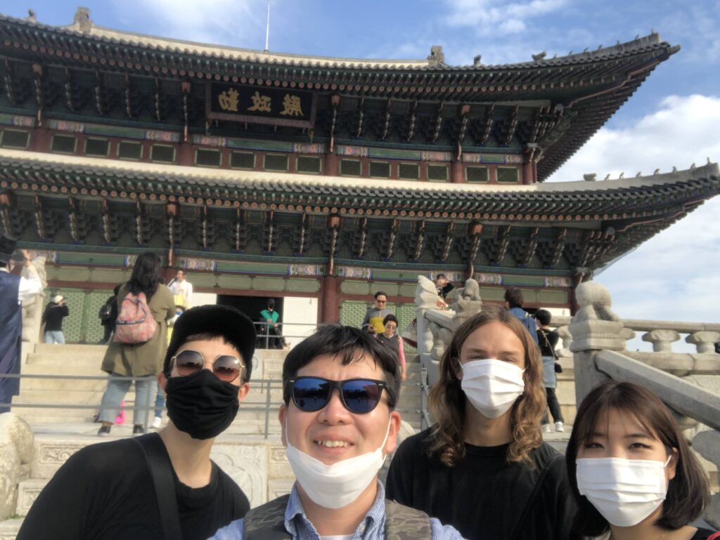 Foreign visitors posing at Gyeongbokgung Palace entrance