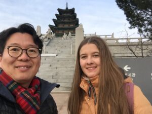 Korean guide with foreign traveler visiting Gyeongbokgung Palace