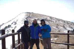 Group of hikers on snowy mountain trail